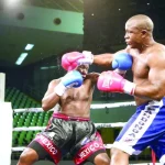 Tanzanian boxer Karim Mandonga (right) exchanges punches with his Ugandan opponent, Kenneth Lukyamuzi in Nairobi on Saturday nigh