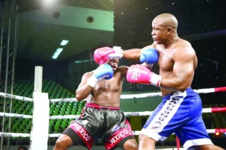 Tanzanian boxer Karim Mandonga (right) exchanges punches with his Ugandan opponent, Kenneth Lukyamuzi in Nairobi on Saturday nigh