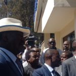 Azimio leader Raila Odinga (wearing a hat) outside the gate of the Directorate of Criminal Investigations (DCI) headquarters on Kiambu Road