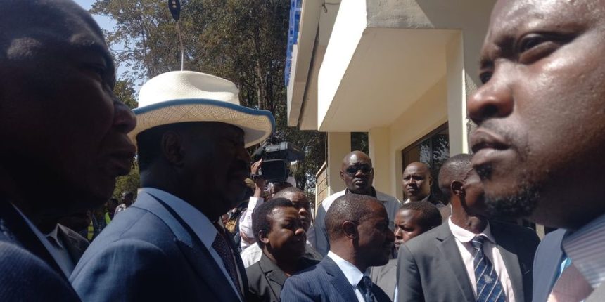 Azimio leader Raila Odinga (wearing a hat) outside the gate of the Directorate of Criminal Investigations (DCI) headquarters on Kiambu Road